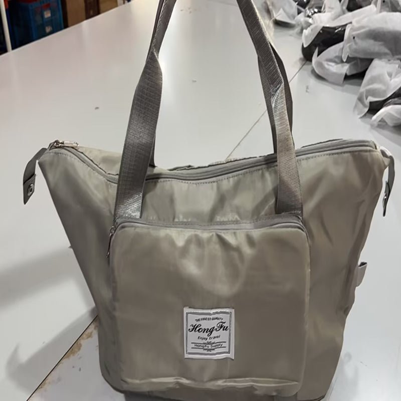 Travel Gym Bag in grey color, showcasing foldable and waterproof design with large capacity for organizing essentials.