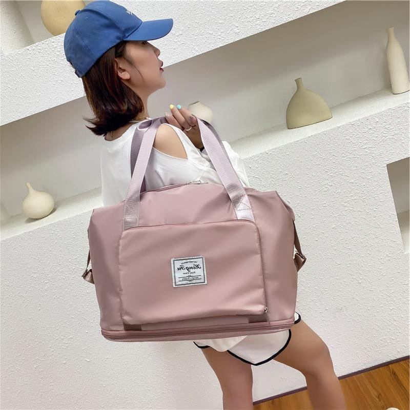 Travel Gym Bag – Foldable, Waterproof & Large Capacity in pink being carried by a woman.