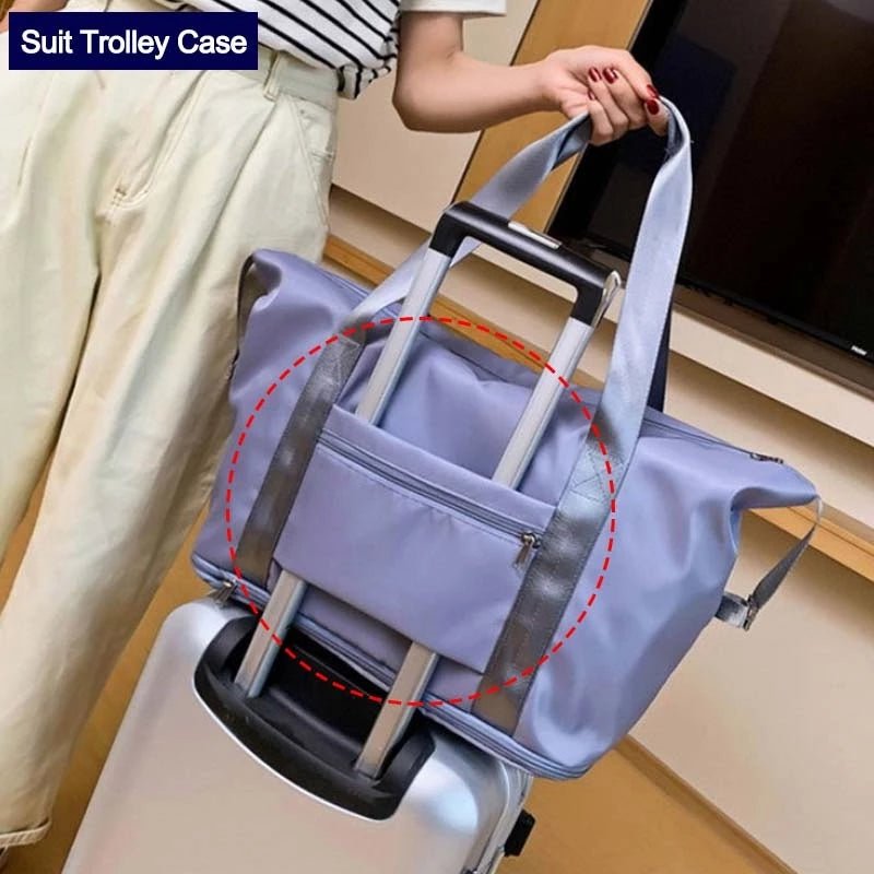 Travel Gym Bag with spacious main compartment and waterproof material, seen on a suitcase for easy transport.